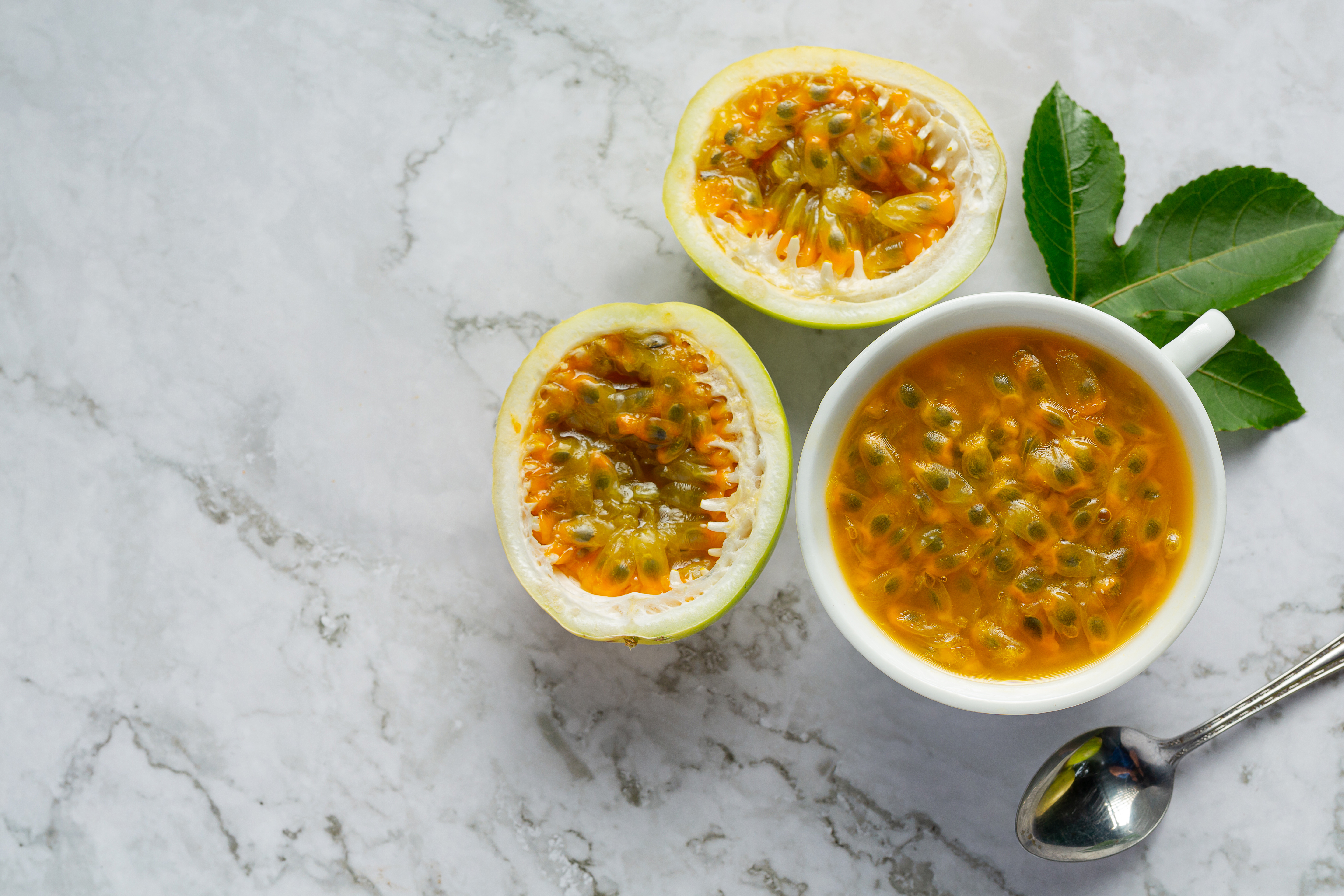 Bowl of golden passionfruit pulp with visible seeds emphasizing fiber for passionfruit gut benefits
