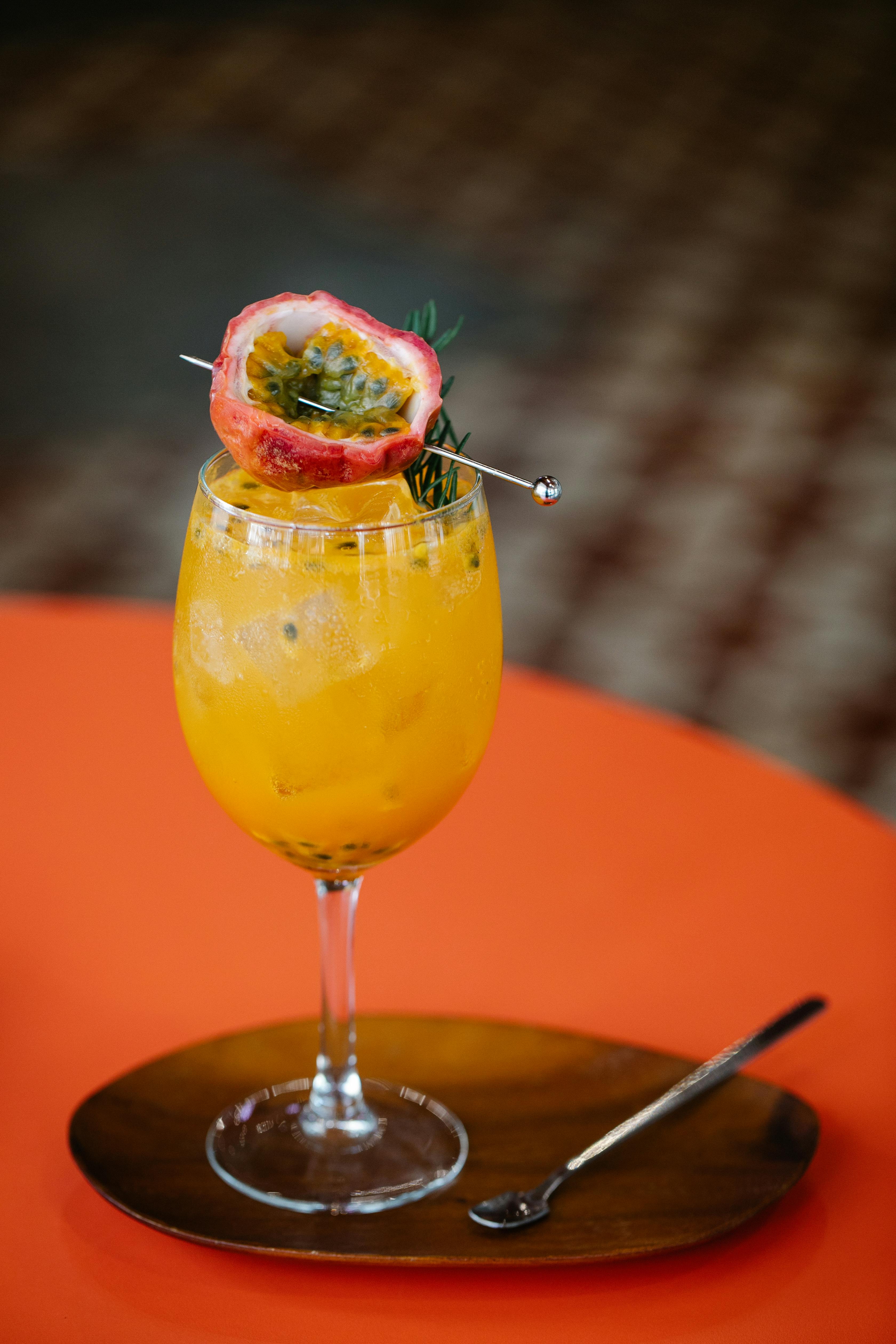 Tall glasses of fresh passionfruit juice with ice and mint leaves